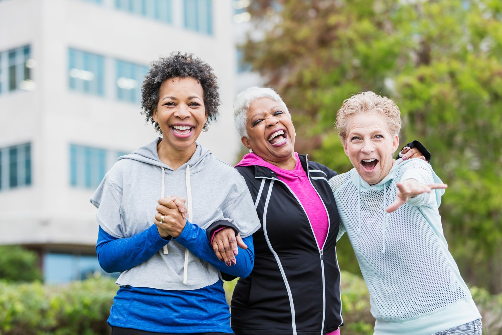 Three older multi-ethnic women hanging out together